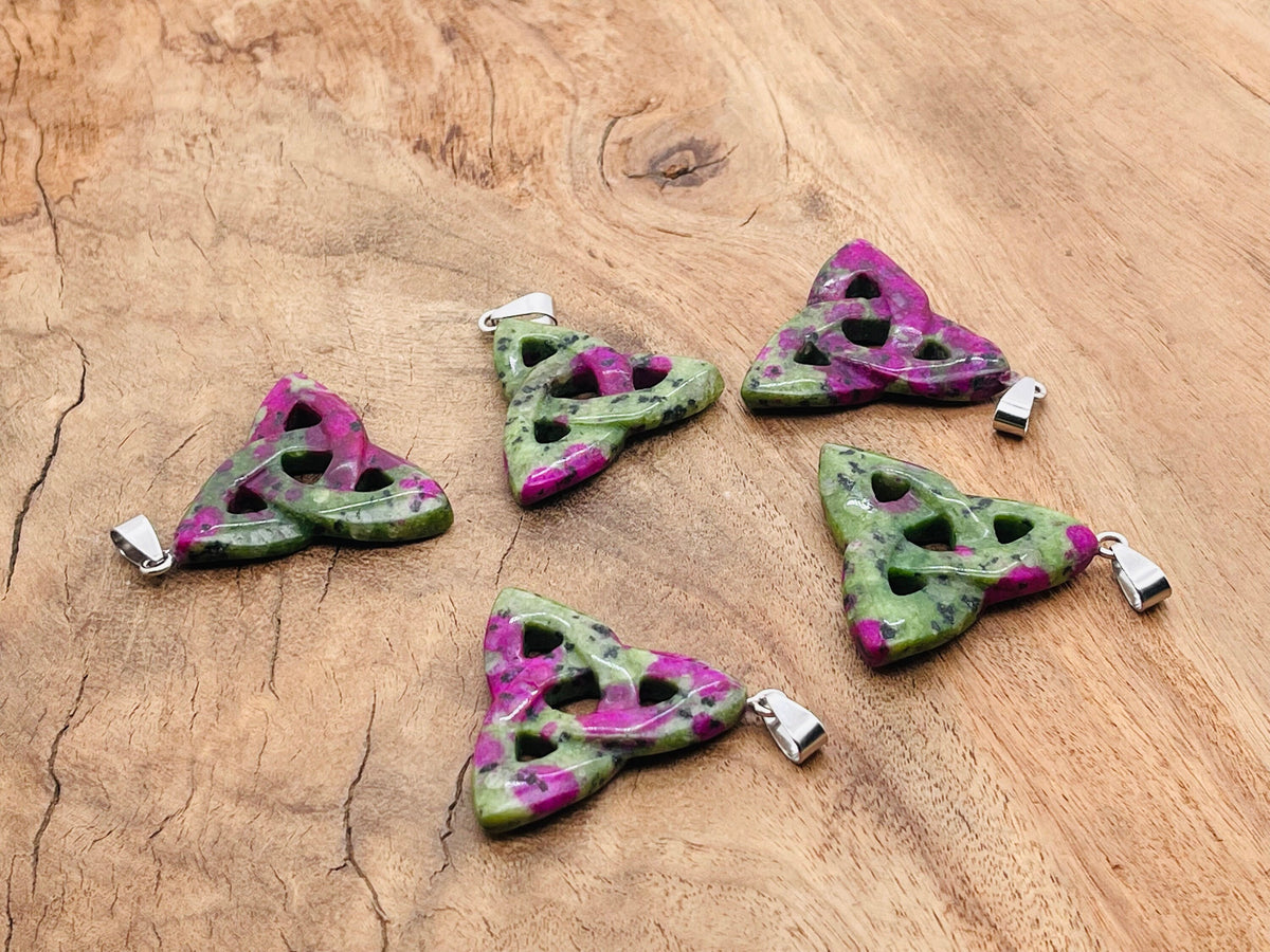 Ruby Zoisite Celtic Knot crystal pendant from GemstoneGO featuring intricate Trinity Crystals design on a silver chain.