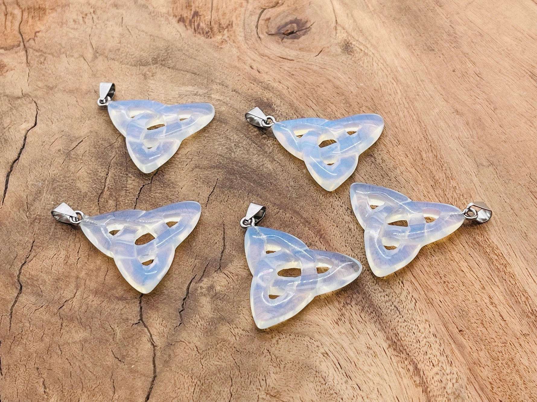 Opalite Celtic Knot crystal pendant featuring Trinity Crystals by GemstoneGO, showcasing intricate design and smooth polished surface.