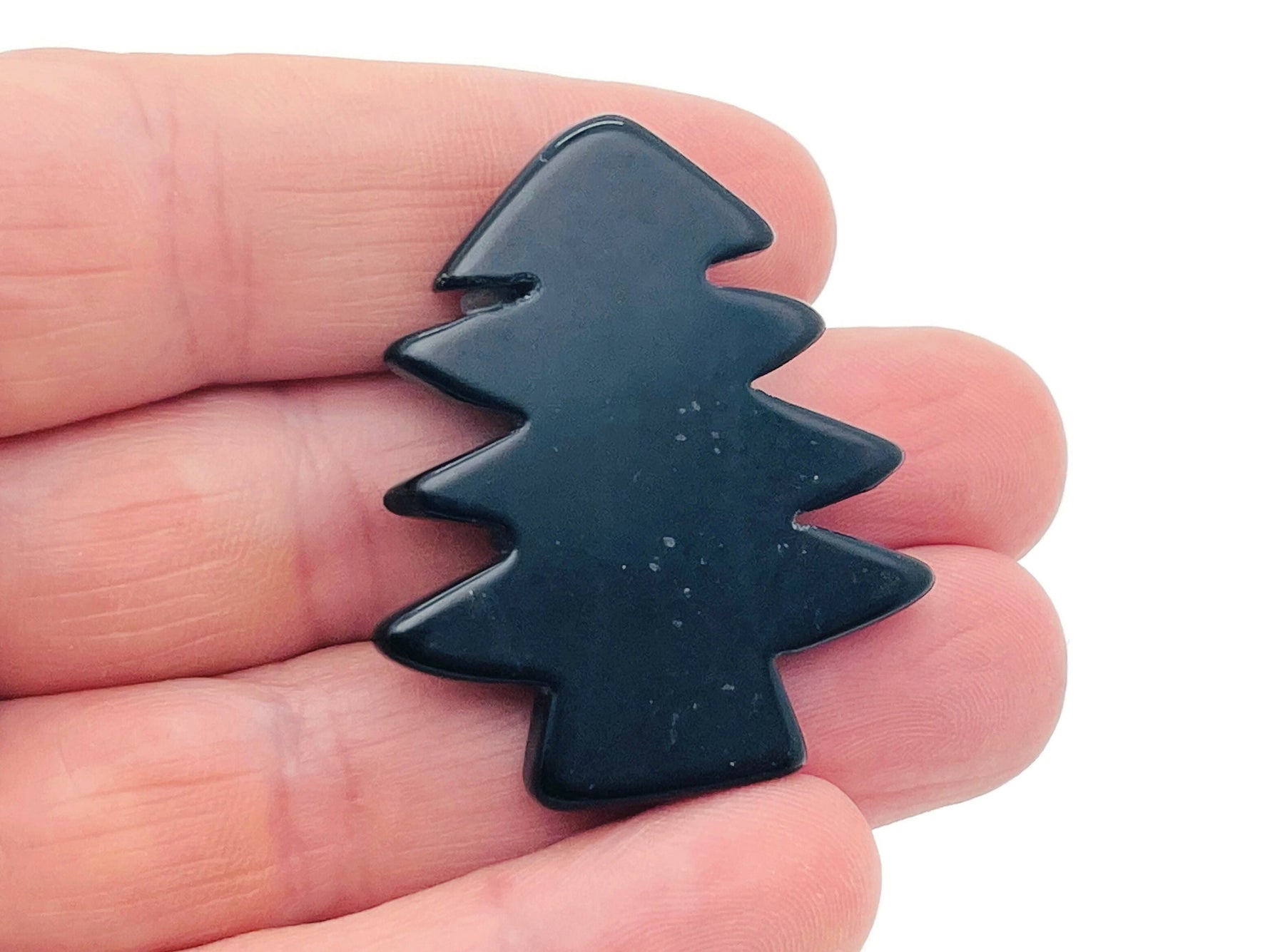 Handmade obsidian pine tree gemstone carving by GemstoneGO, featuring detailed tree design on a polished black stone.