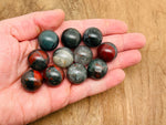 20mm African Bloodstone sphere gemstone from GemstoneGO, polished crystal ball showcasing deep green and red mineral patterns.