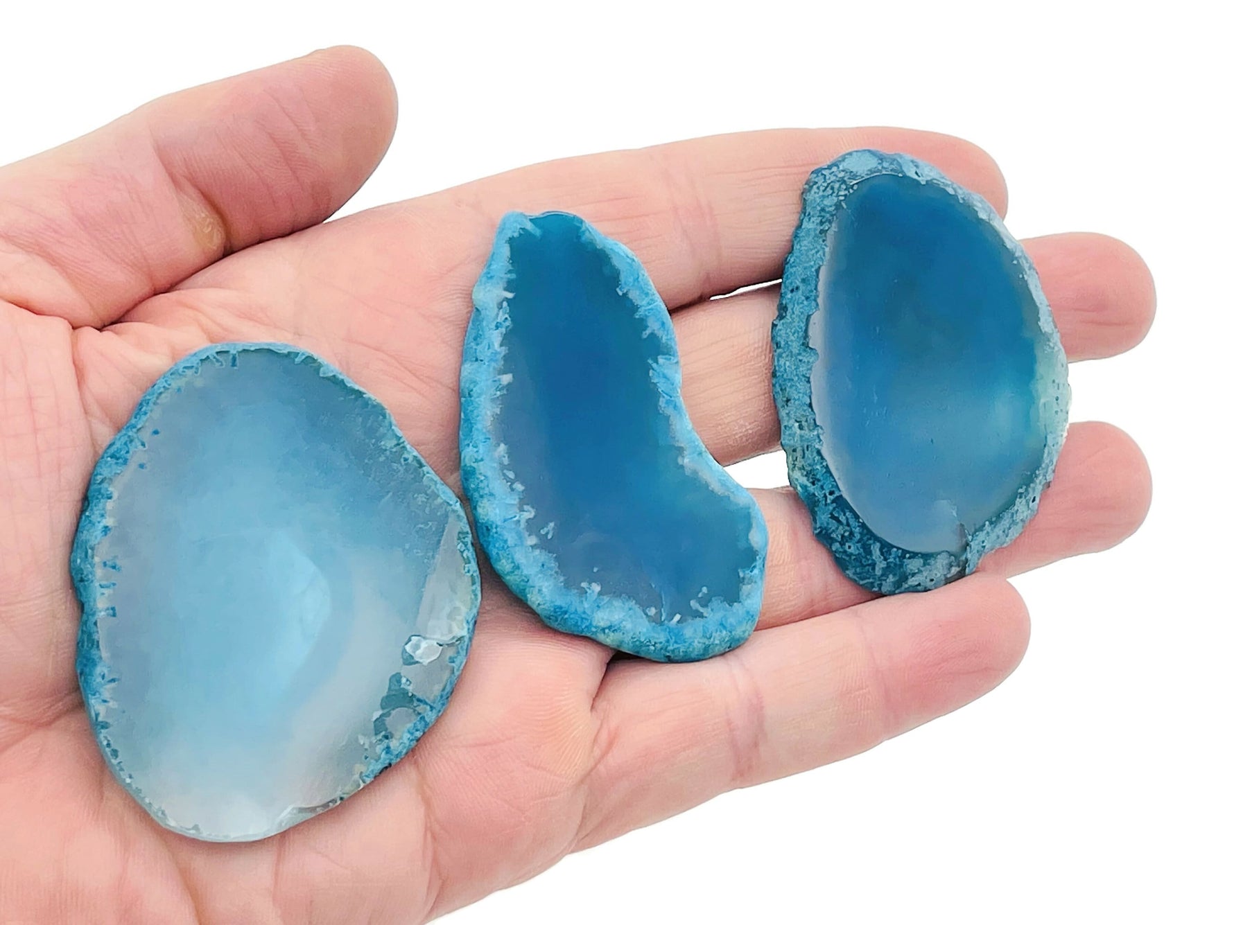 Blue agate slice geode crystal from GemstoneGO, showcasing vivid blue banding and raw, natural crystal formations.