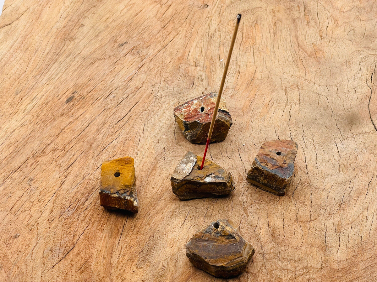 Handmade tiger eye rough crystal incense holder with carved design, perfect for holding incense sticks.