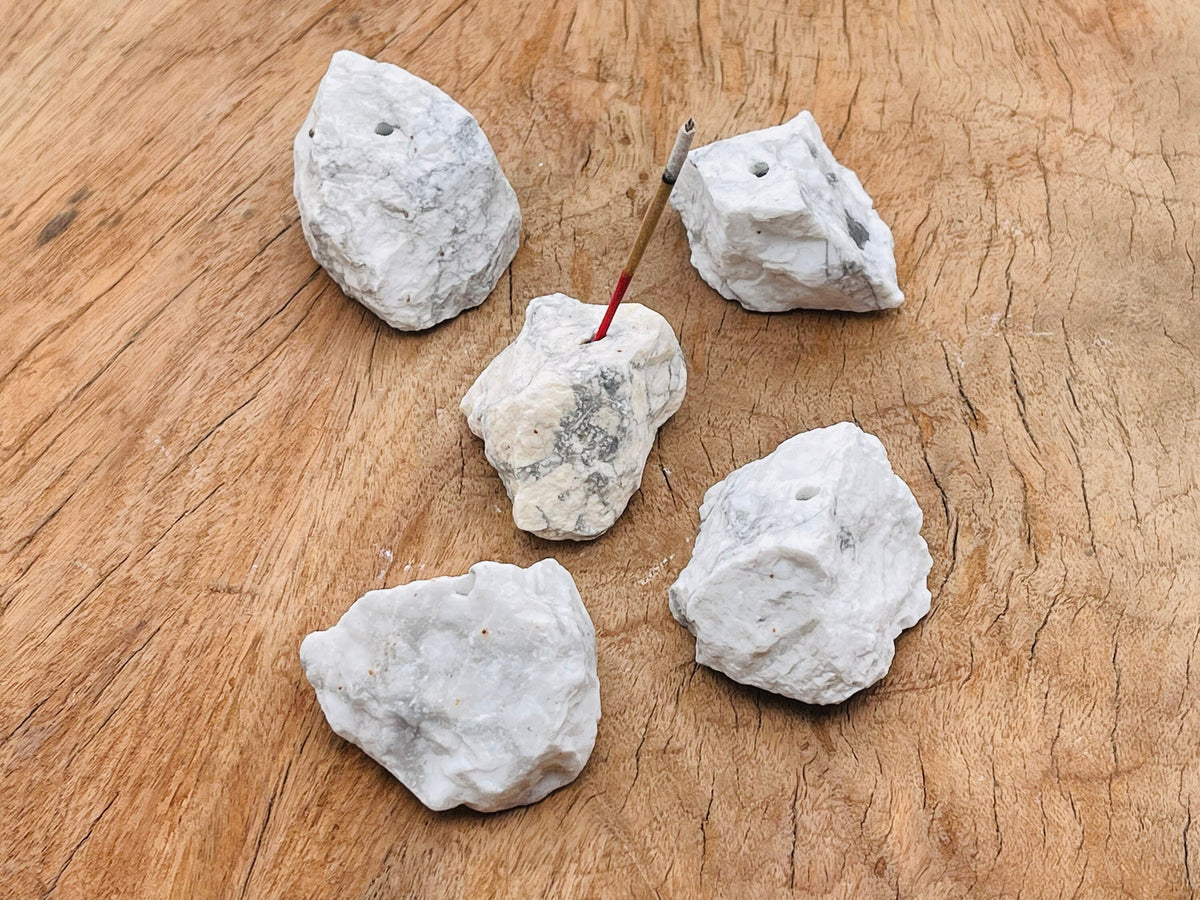 Handmade howlite rough crystal incense holder with carved design, perfect for holding incense sticks in a natural gemstone display.