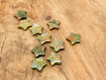 Unakite star-shaped gemstone pendant, 30mm, from GemstoneGO, with vibrant green and pink mineral patterns on a smooth surface.