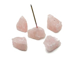 Handmade rose quartz crystal incense holder with carved design for incense sticks, showcasing a natural pink gemstone aesthetic.