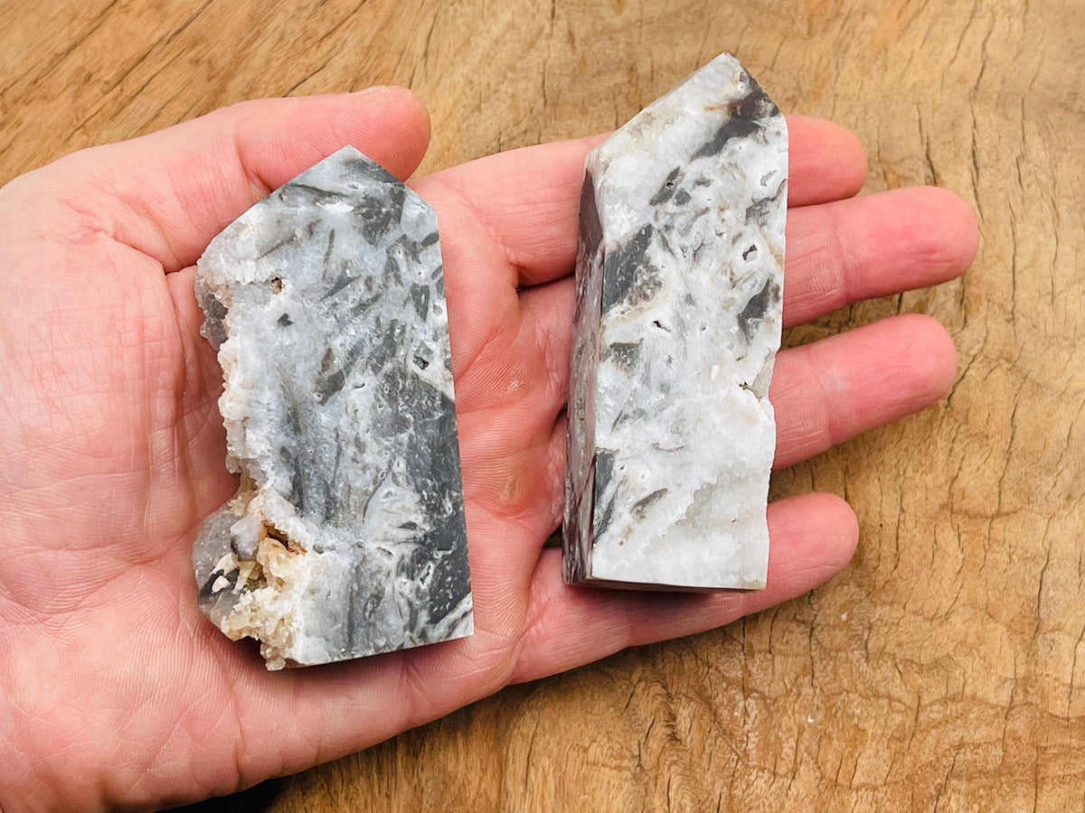 Sphalerite obelisk tower crystal from GemstoneGO, showing a dark, polished mineral with natural striations and a pointed top.
