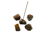 Handmade Tiger Eye rough crystal incense holder with carved design, perfect for holding incense sticks in a natural gemstone display.