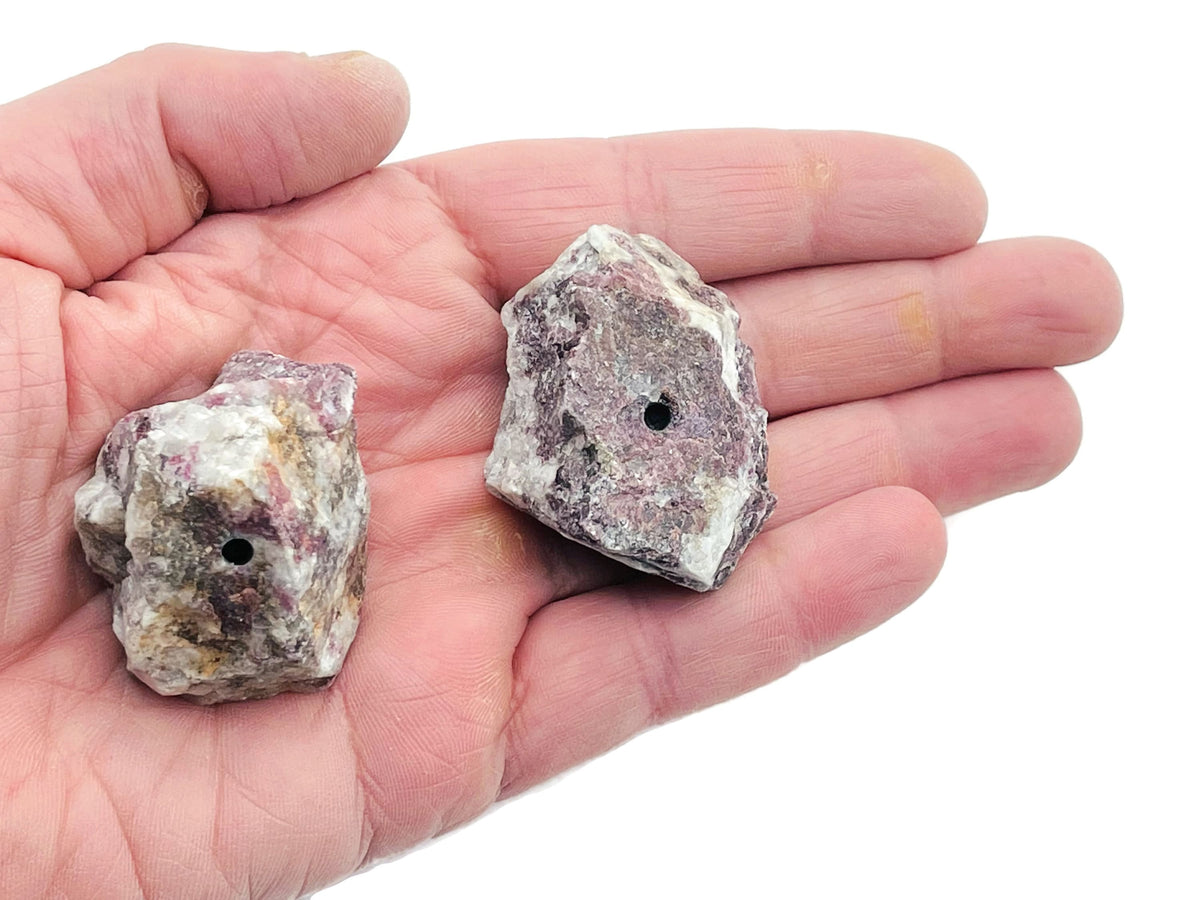Handmade plum blossom carved tourmaline rough crystal incense holder with a natural stone appearance and space for incense sticks.
