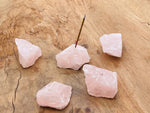 Handmade rose quartz rough crystal incense holder with carved design, ideal for holding incense sticks and enhancing decor.