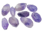 Amethyst double obelisk tower crystal from GemstoneGO, showing purple gemstone with natural crystal formations and polished surfaces.