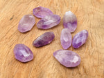 Amethyst double obelisk tower crystal from GemstoneGO, showing purple mineral structure and polished stone surface.