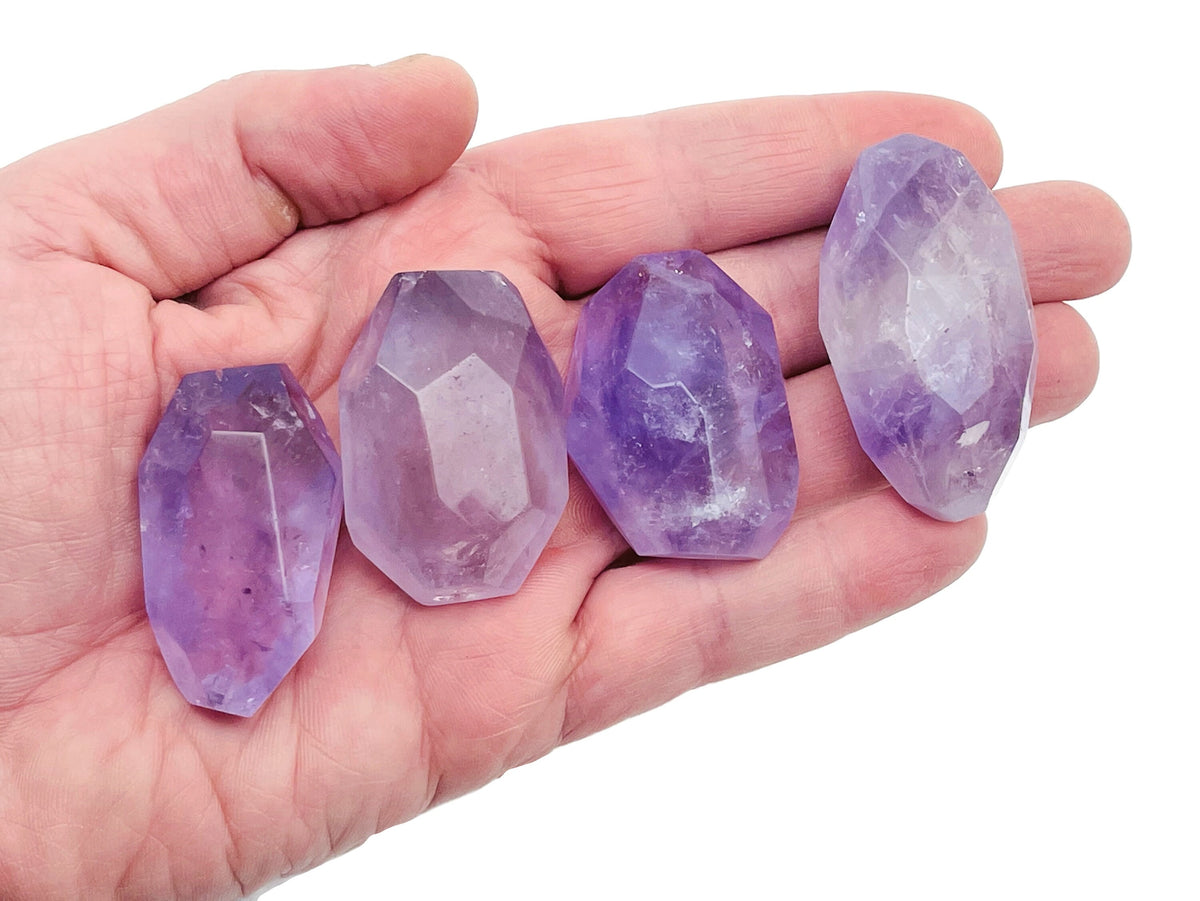 Amethyst double obelisk tower crystal from GemstoneGO, featuring purple gemstone with natural stone texture and pointed top.