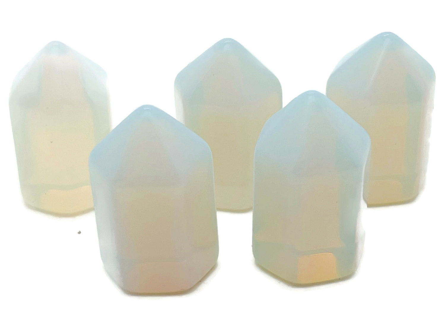 Opalite obelisk tower crystal from GemstoneGO, 25mm, showcasing a smooth, translucent white gemstone with subtle blue glow.