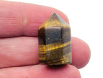 Tiger Eye obelisk tower crystal, 25mm, from GemstoneGO, showing a polished brown and gold striped gemstone with pointed shape.