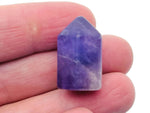 Amethyst obelisk tower crystal from GemstoneGO, 25mm tall, showcasing deep purple hues and pointed geometric shape.