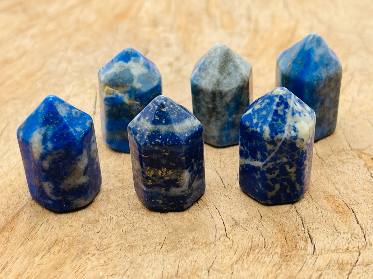 Lapis Lazuli obelisk tower crystal from GemstoneGO, 25mm, showcasing deep blue gemstone with gold-colored pyrite inclusions.