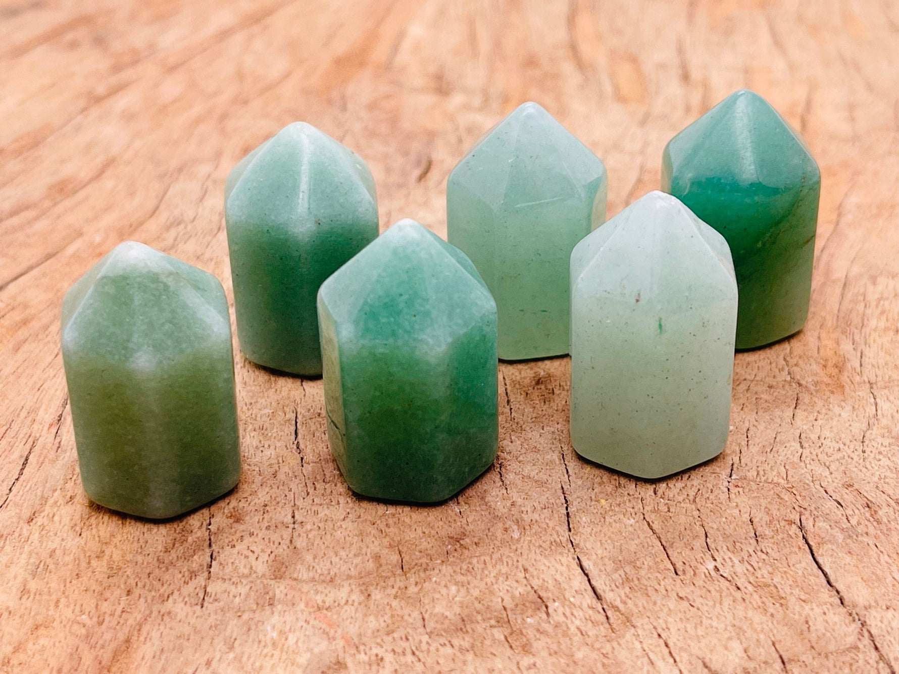 Aventurine obelisk tower crystal from GemstoneGO, 25mm, smooth green gemstone with natural mineral patterns and pointed top.