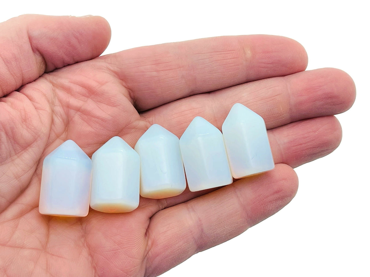 Opalite obelisk tower crystal, 25mm, from GemstoneGO, showcasing a smooth, translucent gemstone with a pointed obelisk shape.