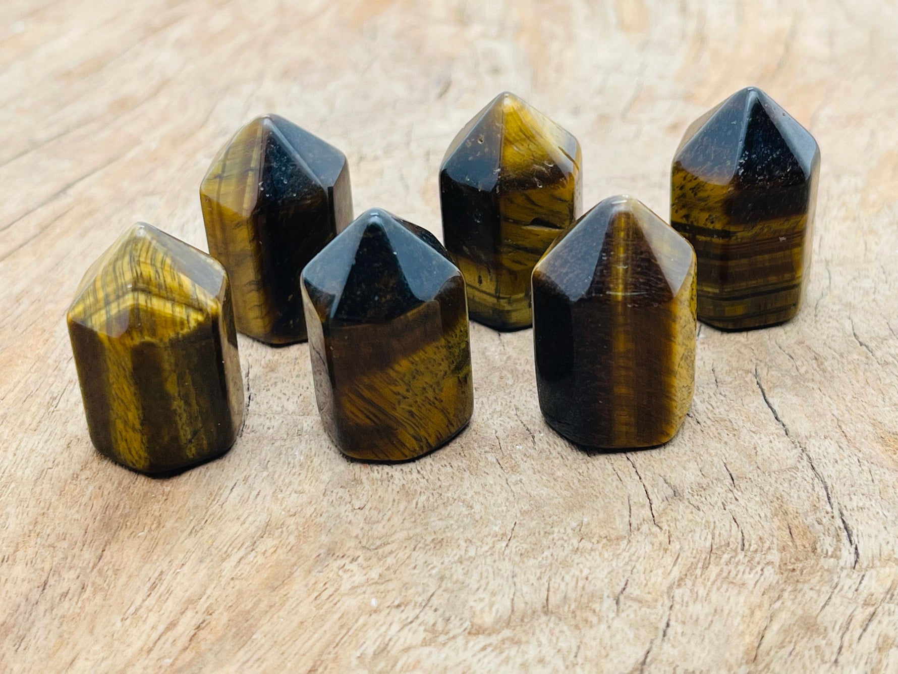 Tiger Eye Obelisk Tower crystal 25mm from GemstoneGO, showcasing the polished, golden-brown stone with natural banding details.