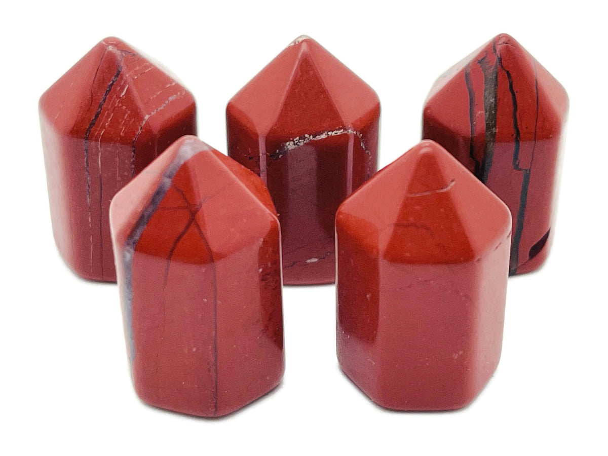 Red Jasper obelisk tower crystal, 25mm, from GemstoneGO, showcasing a polished red gemstone with natural striations and smooth surface.