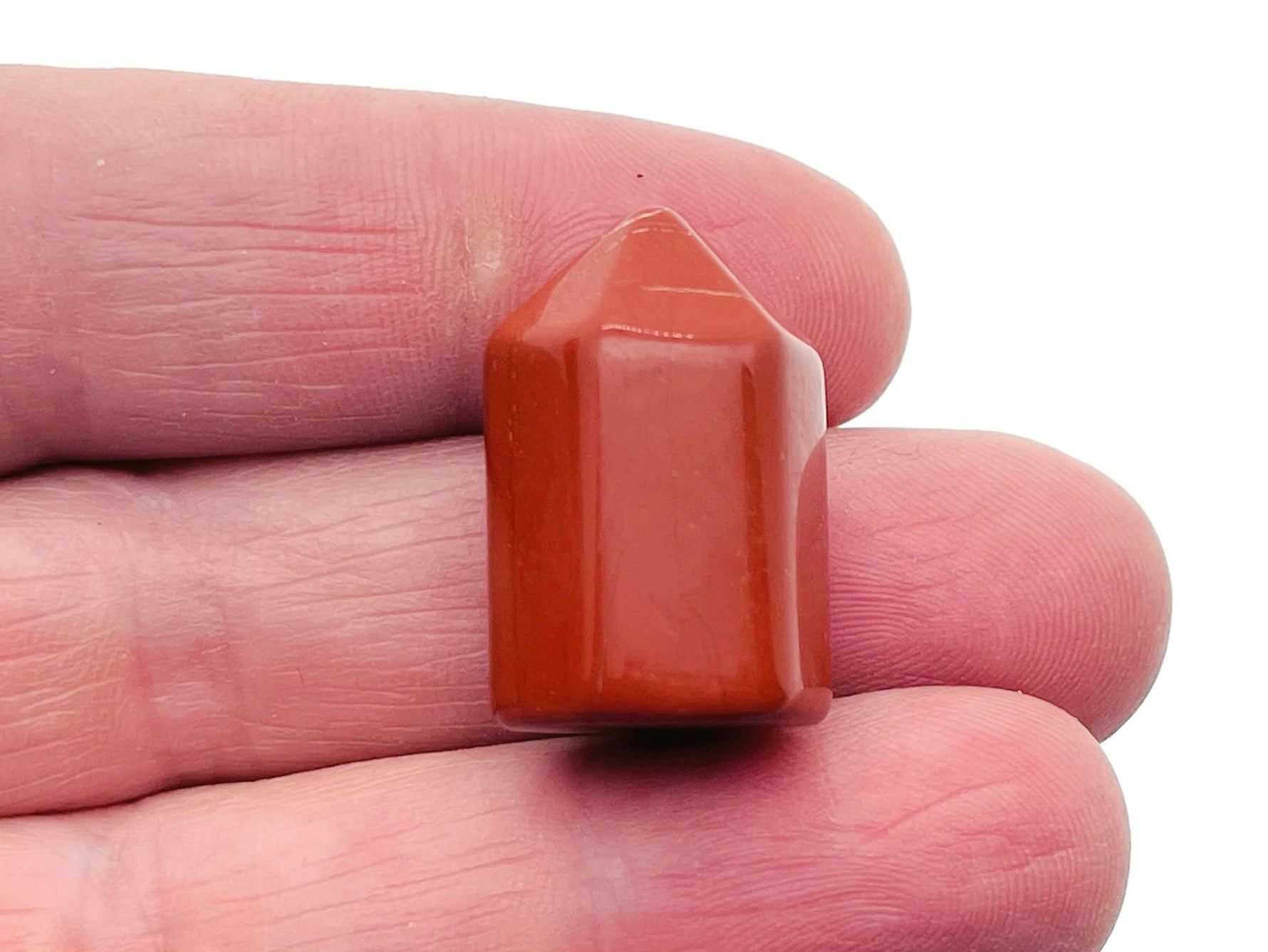 Red Jasper obelisk tower crystal from GemstoneGO, 25mm tall, showcasing rich red color and smooth polished surface.