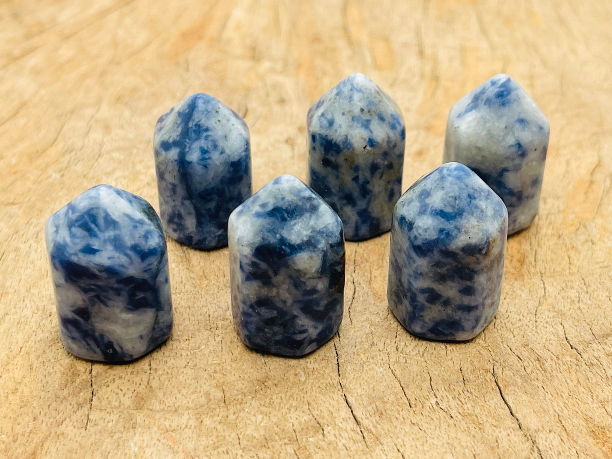 Blue Spot Jasper obelisk tower crystal from GemstoneGO, showcasing a polished blue and brown gemstone obelisk with natural patterns.