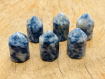 Blue Spot Jasper obelisk tower crystal from GemstoneGO, showcasing a polished blue and brown gemstone obelisk with natural patterns.