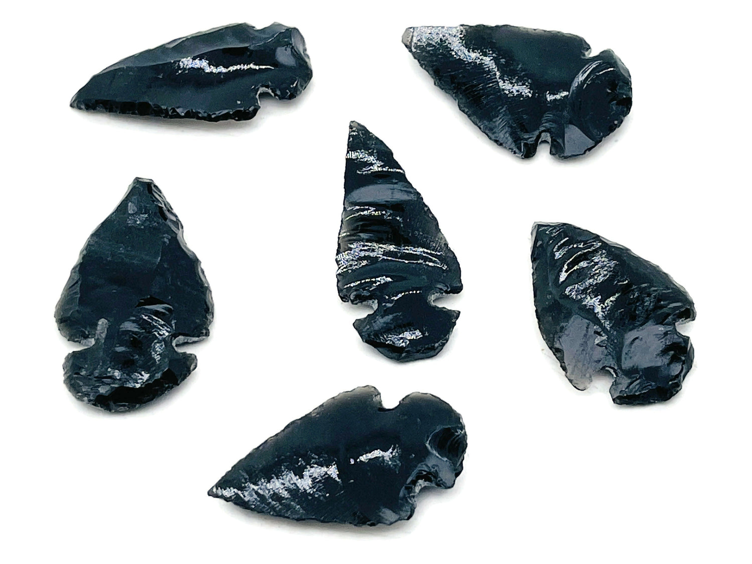 Black obsidian arrowhead carving gemstone with pointed spear shape and detailed craftsmanship, perfect for collection or jewelry making.