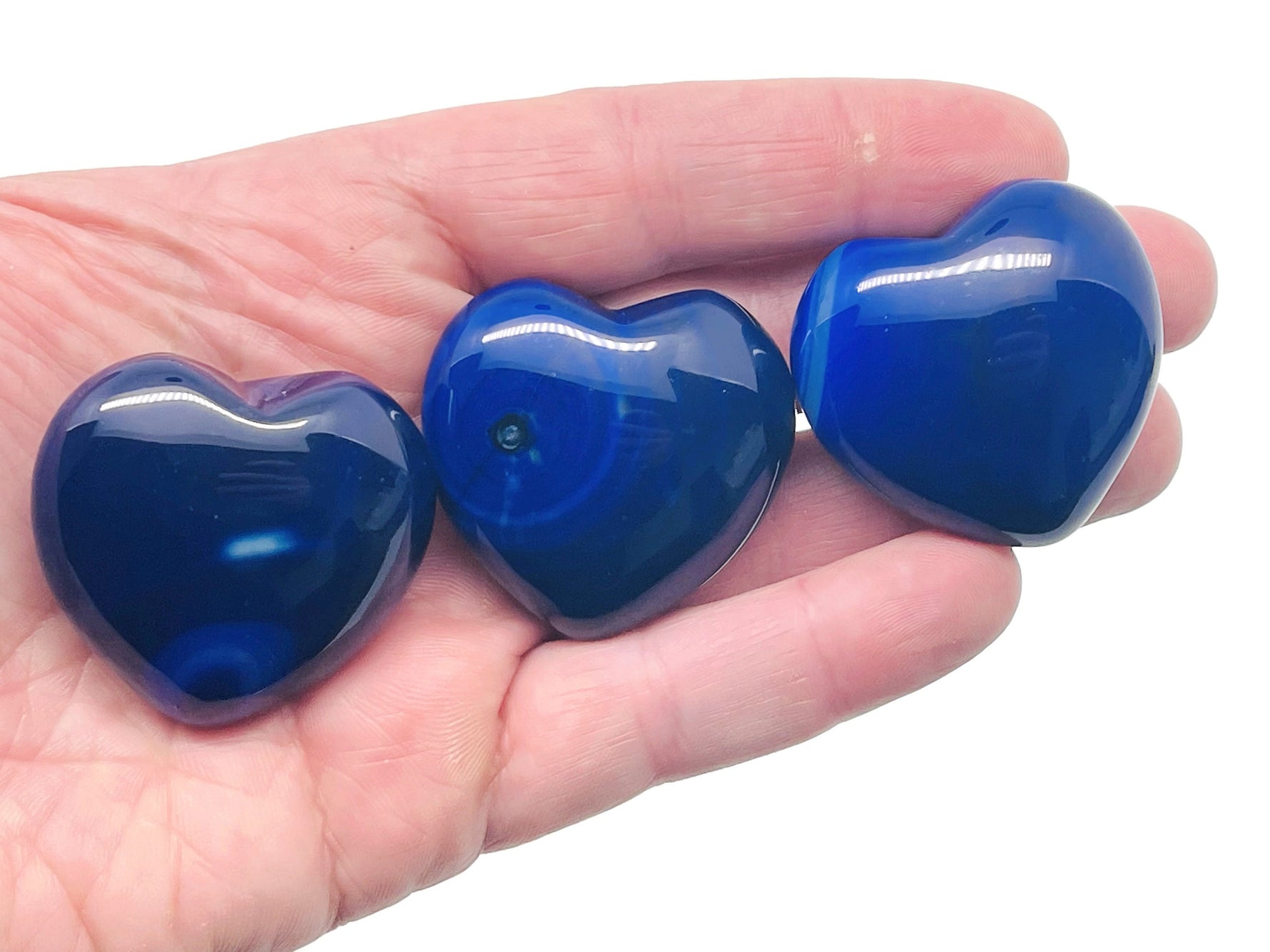 Blue agate heart-shaped gemstone, 40mm, from GemstoneGO showing a polished blue agate pendant with natural banding and smooth surface.