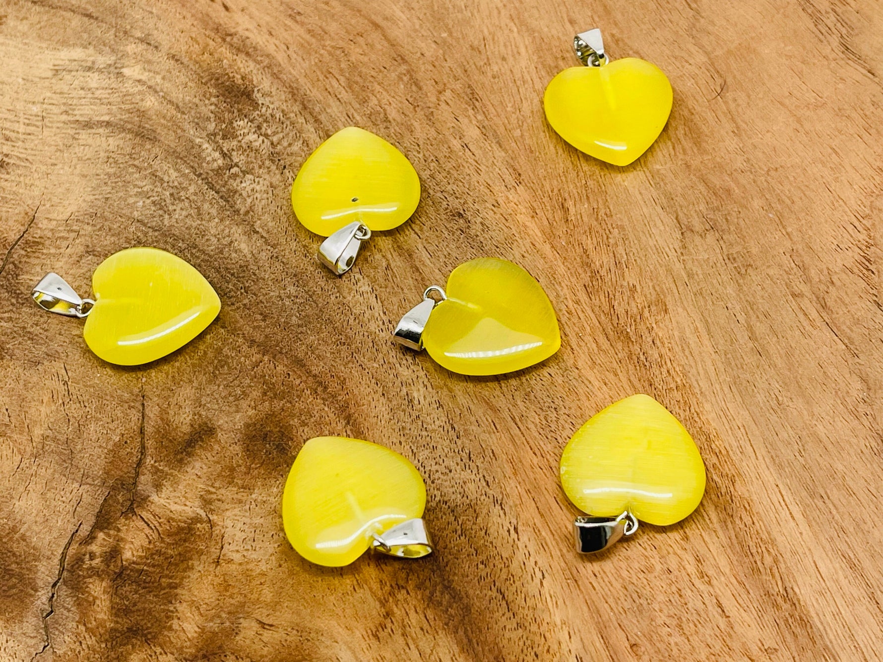 Yellow cat's eye heart pendant with crystal accents from GemstoneGO, showcasing a mini healing jewelry piece.