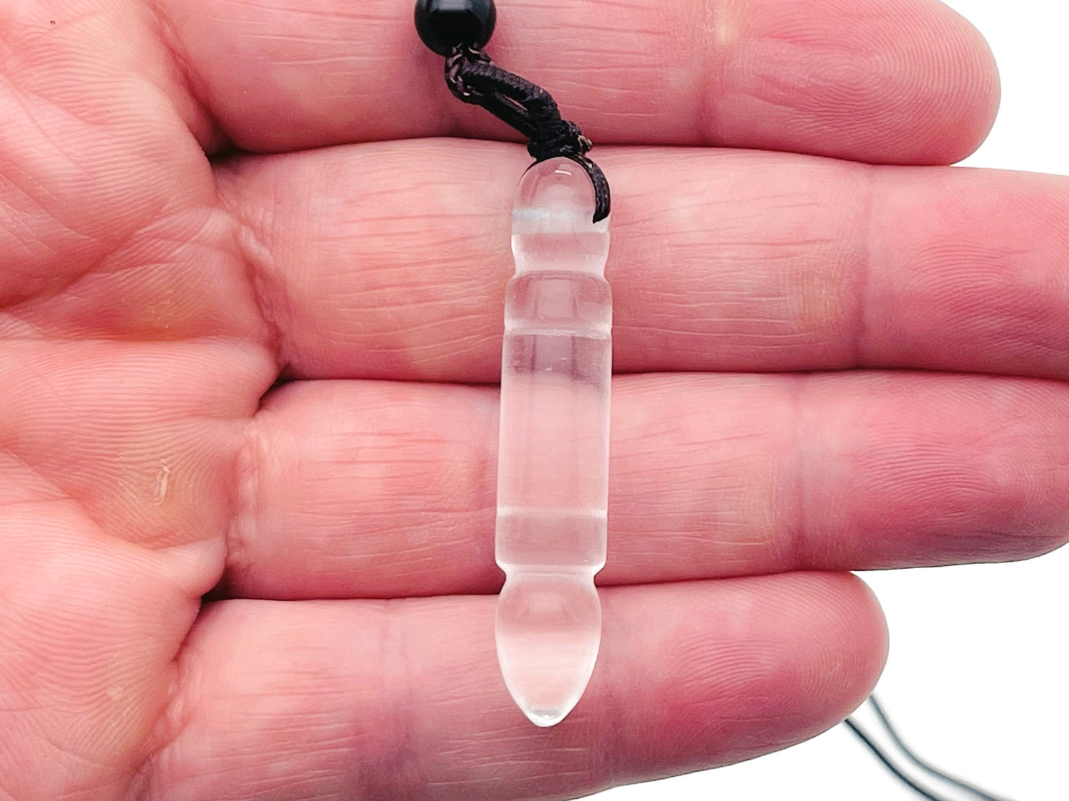 Clear Quartz Bullet Crystal Necklace by GemstoneGO featuring a sleek, polished quartz pendant on a delicate chain.