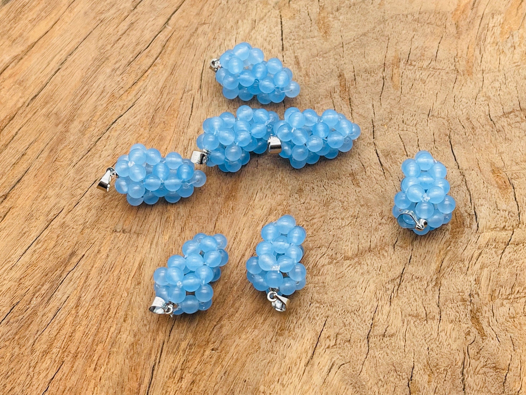 Blue agate grape-shaped crystal pendant with gemstone details, showcasing a vibrant, polished gemstone jewelry piece from GemstoneGO.