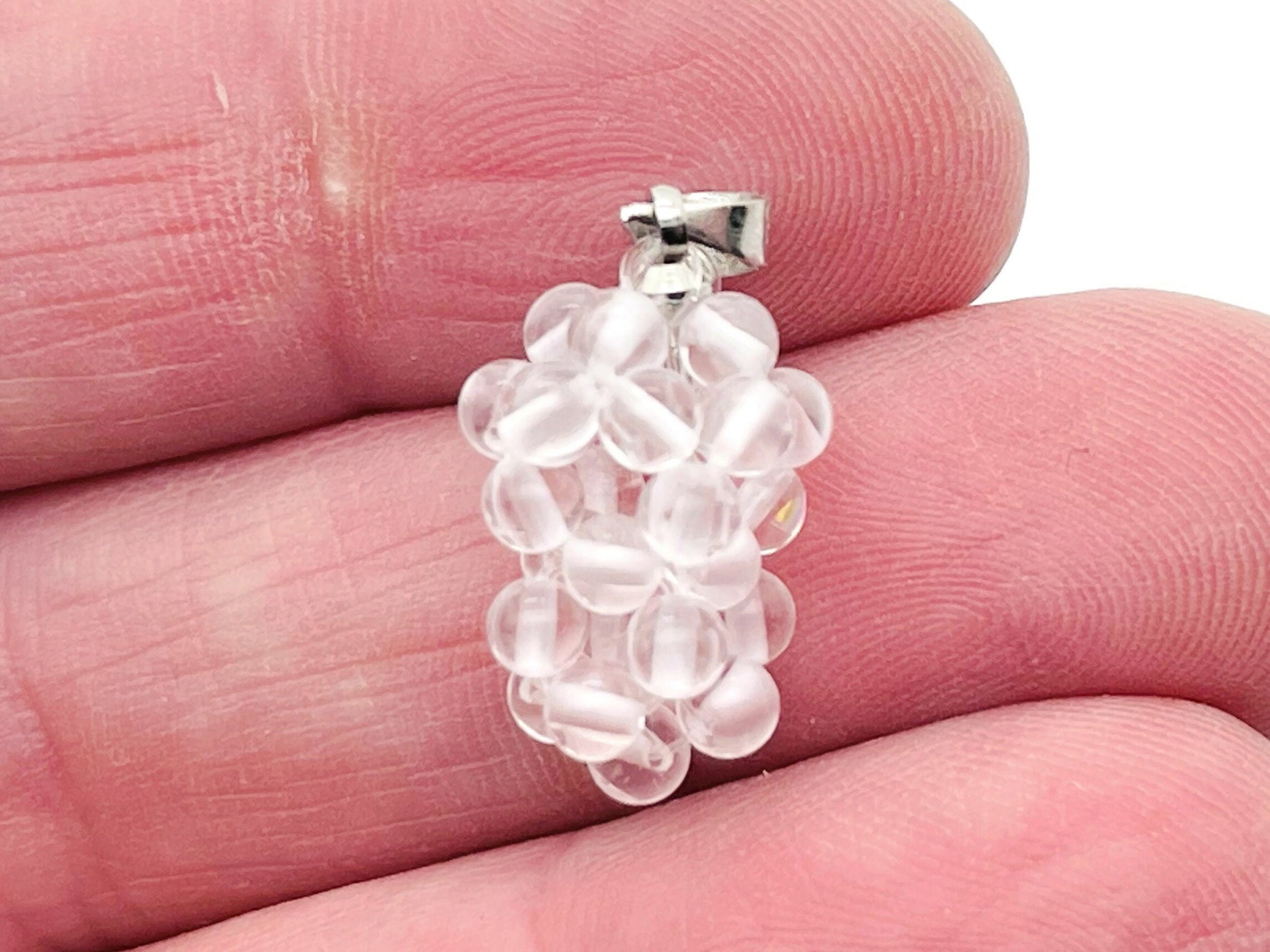 Clear Quartz Grape Crystal pendant from GemstoneGO featuring a detailed crystal grape design on a silver chain.