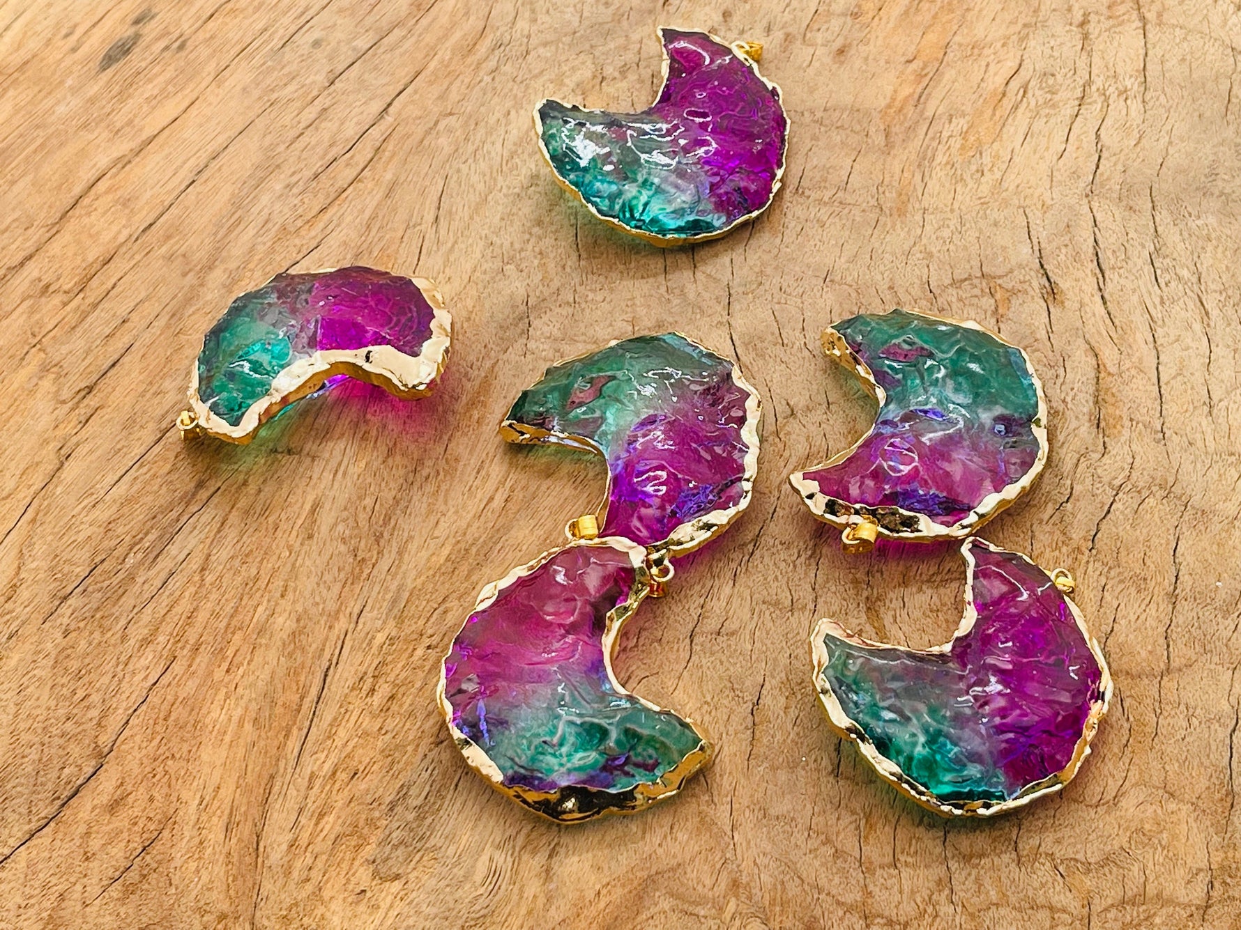 Blue and purple Rainbow Aura Moon Crystal pendant with love stone design from GemstoneGO, showcasing a shimmering, colorful aura finish.
