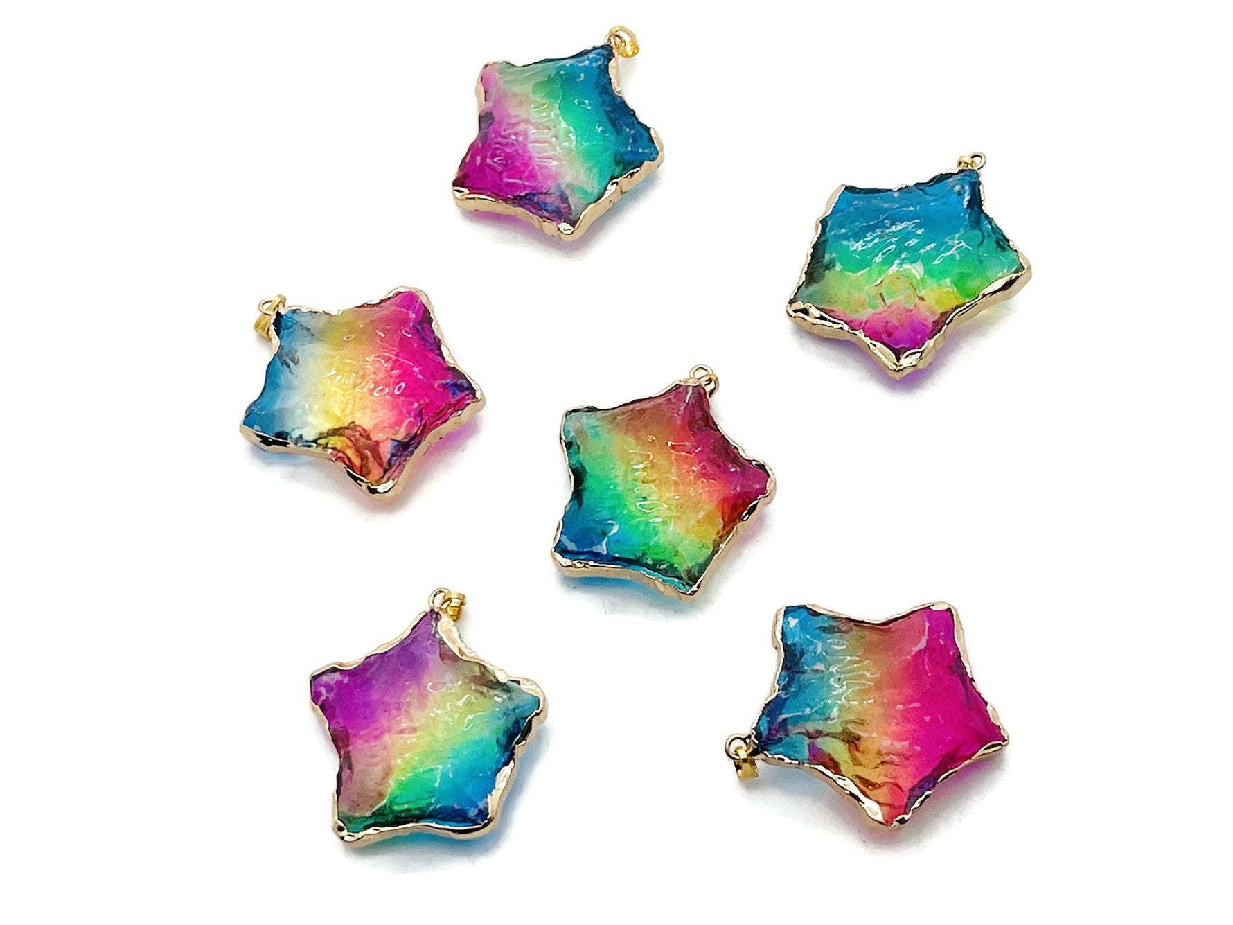 Pink, yellow, and blue rainbow aura star crystal pendant from GemstoneGO, showcasing a loose colorful gemstone with a star shape.