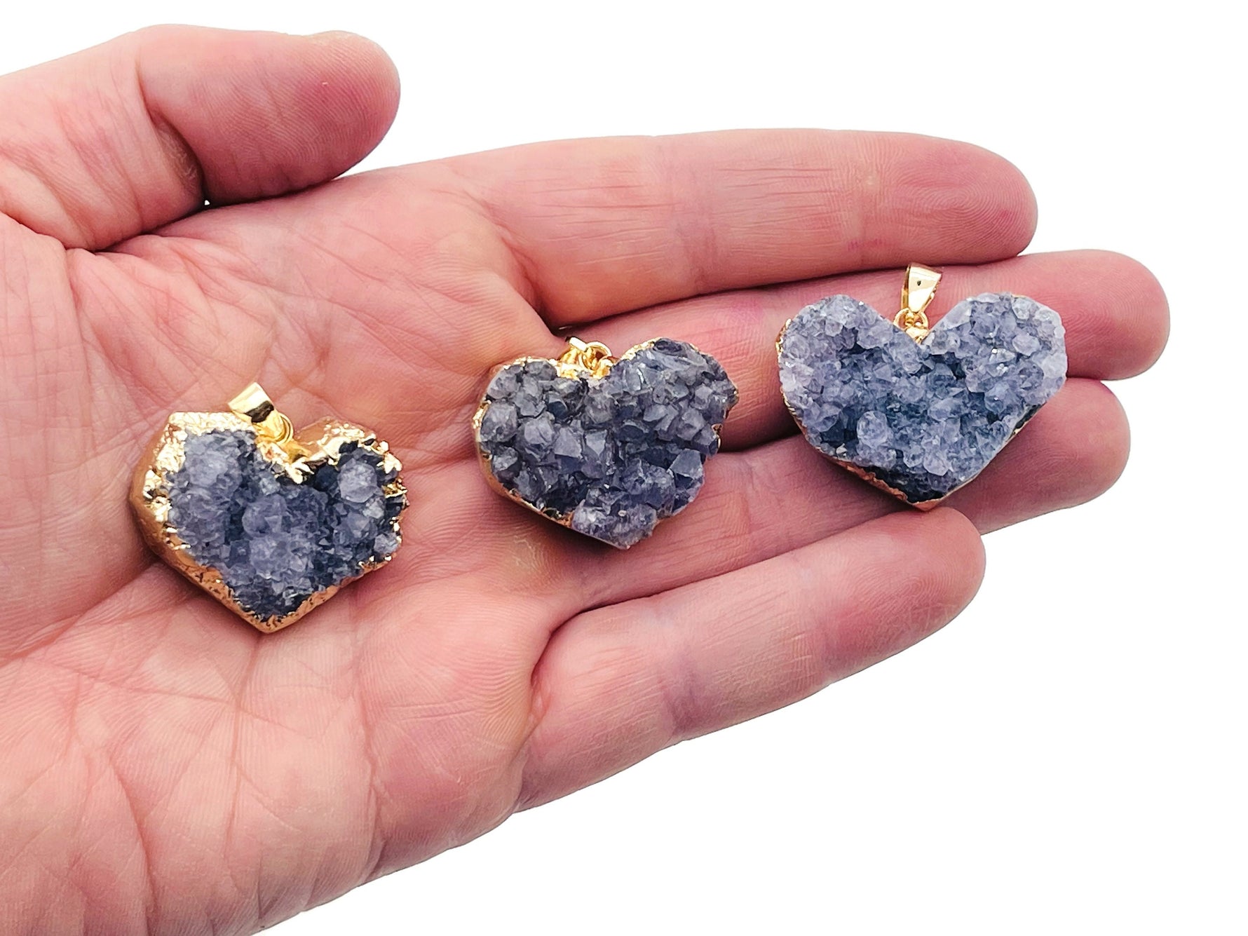 Amethyst heart cluster crystal pendant by GemstoneGO featuring a purple amethyst heart-shaped cluster on a silver chain.