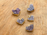 Amethyst heart cluster crystal pendant by GemstoneGO, showcasing a purple amethyst gemstone with a heart shape and natural crystal texture.