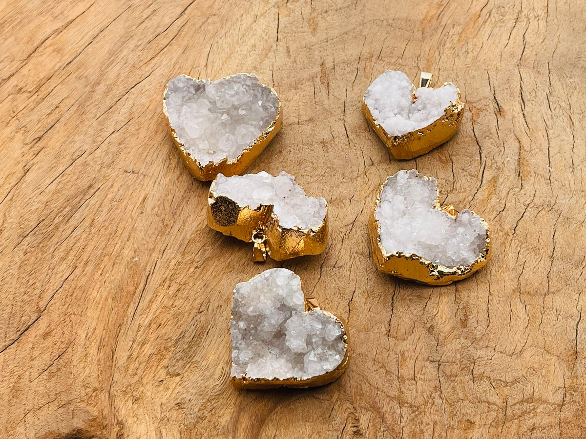 Quartz heart cluster crystal pendant from GemstoneGO featuring a natural quartz heart-shaped cluster on a silver chain.