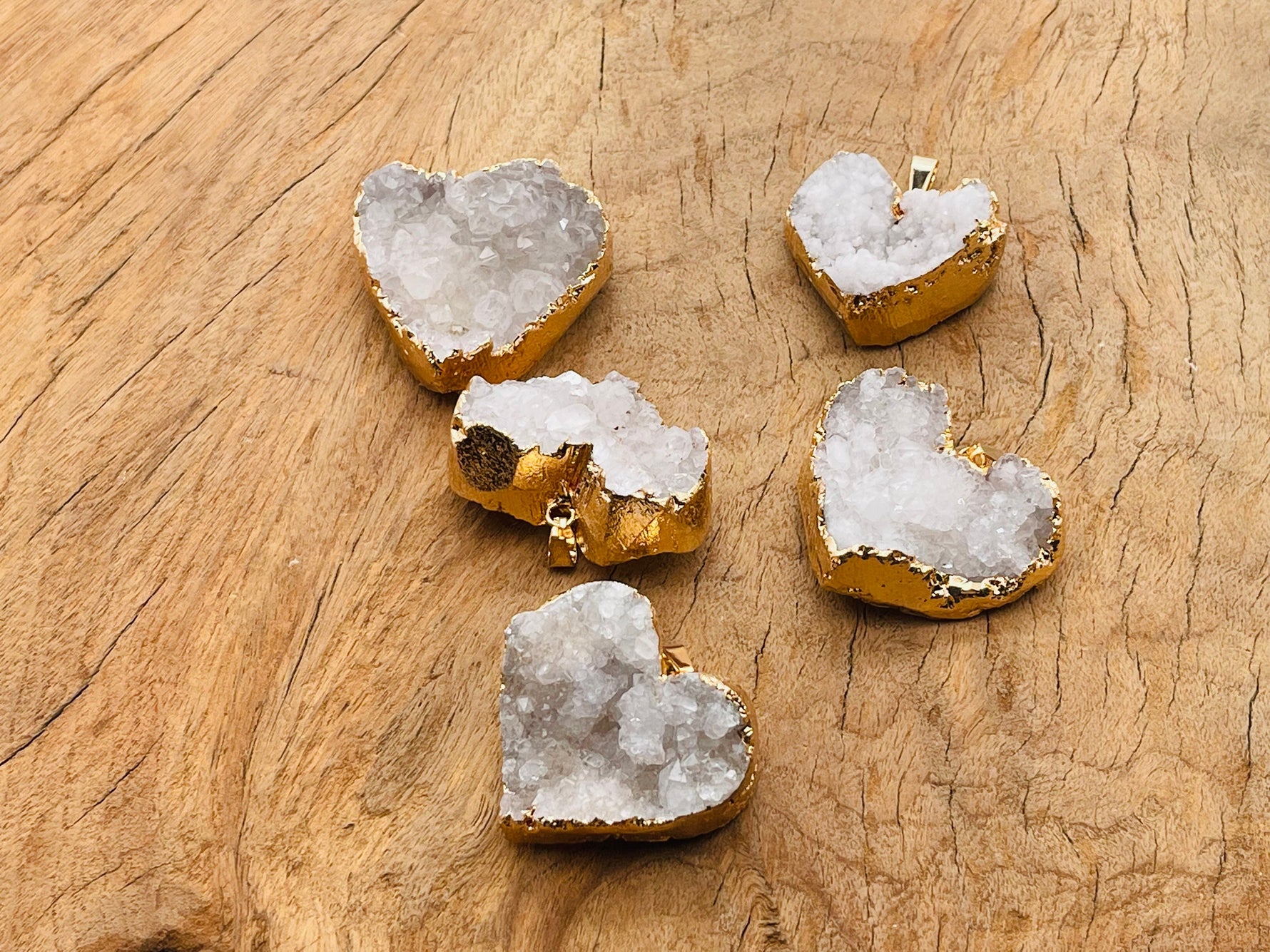 Quartz heart cluster crystal pendant from GemstoneGO featuring a natural quartz heart-shaped cluster on a silver chain.