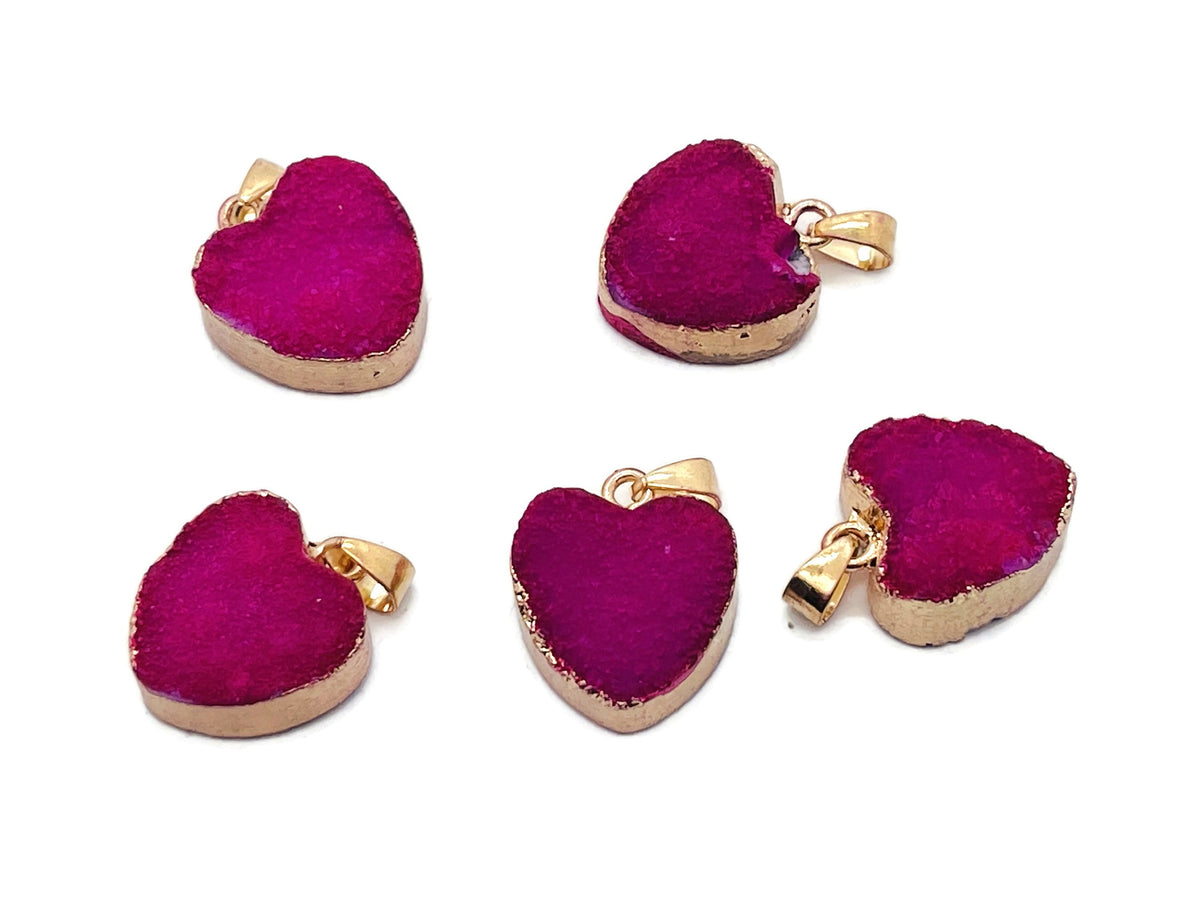 Pink agate heart geode crystal pendant with druzy slice, showcasing vibrant pink tones and natural gemstone textures.
