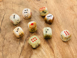 Carved gemstone crystal dice made from Afghanistan jade, featuring intricate gemstone craftsmanship by GemstoneGO.