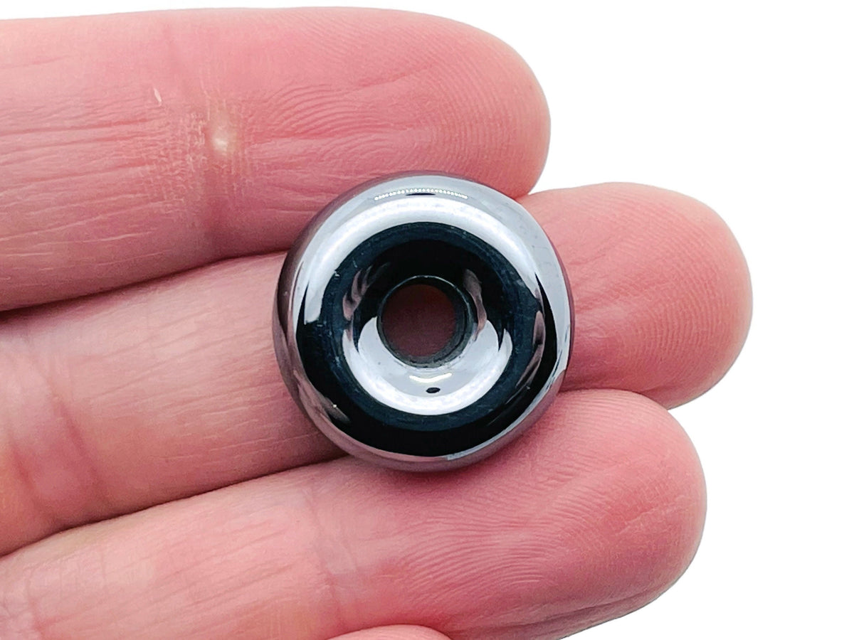20mm terahertz crystal donut with Pi Stone from GemstoneGO, showcasing a polished, rounded gemstone with intricate natural patterns.