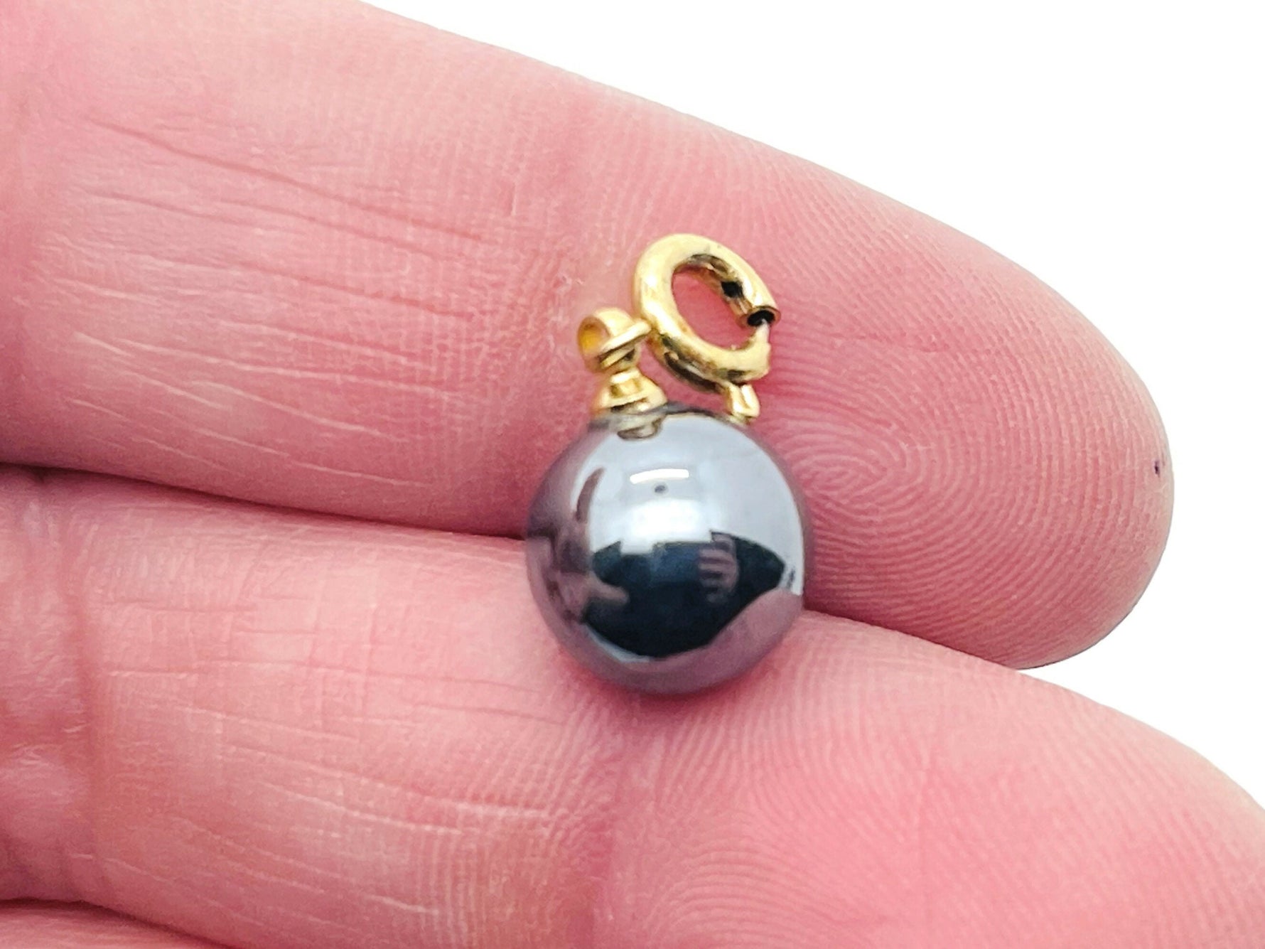 Terahertz Ball gemstone pendant from GemstoneGO, showcasing a polished, spherical jewelry-making gemstone in vibrant colors.