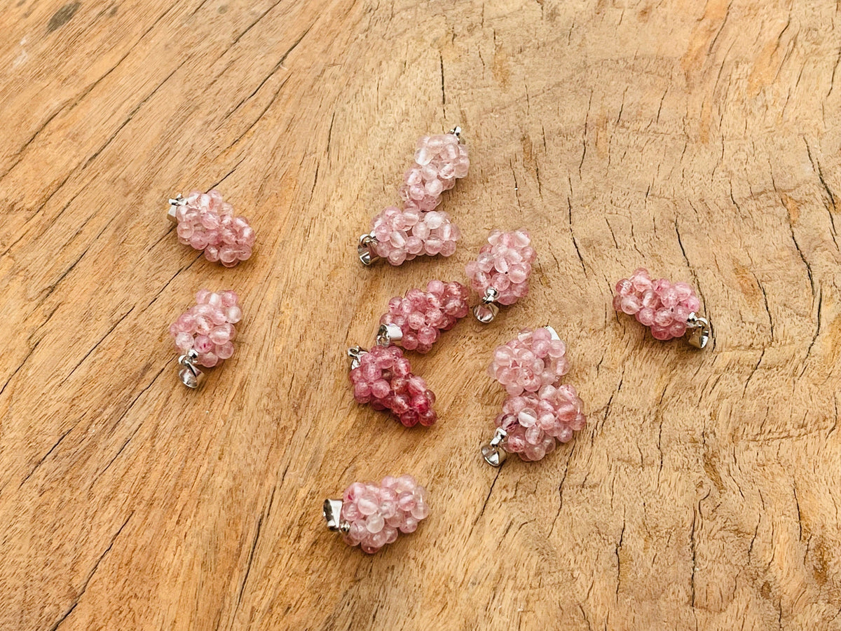 Strawberry Quartz Grape Crystal Pendant by GemstoneGO featuring a vibrant crystal grape design on a silver chain.