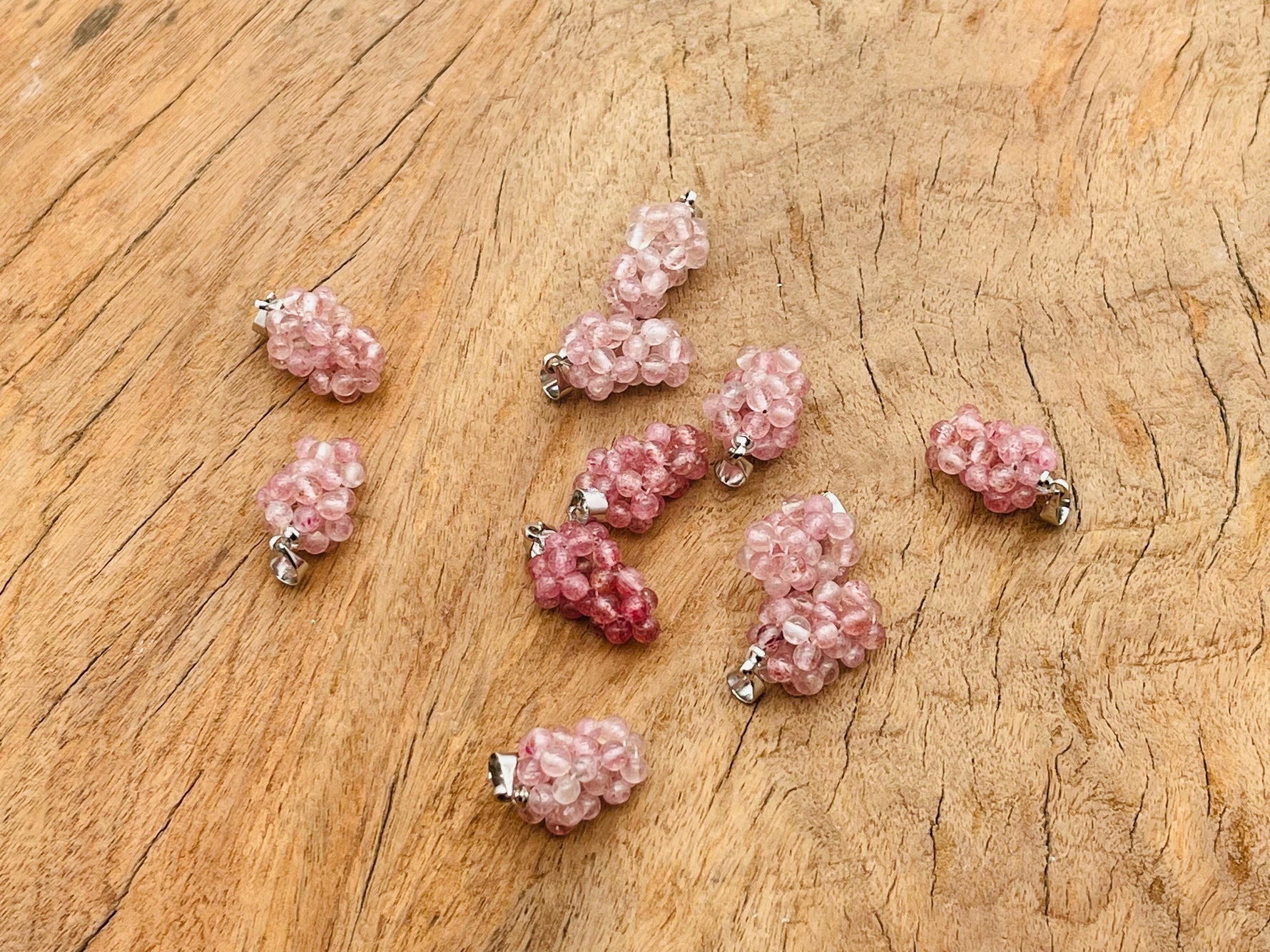 Strawberry Quartz Grape Crystal Pendant by GemstoneGO featuring a vibrant crystal grape design on a silver chain.