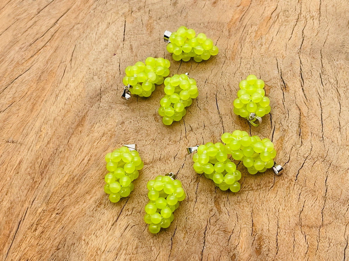 Green agate and grape-shaped crystal pendant from GemstoneGO featuring vibrant green stones and detailed grape design.