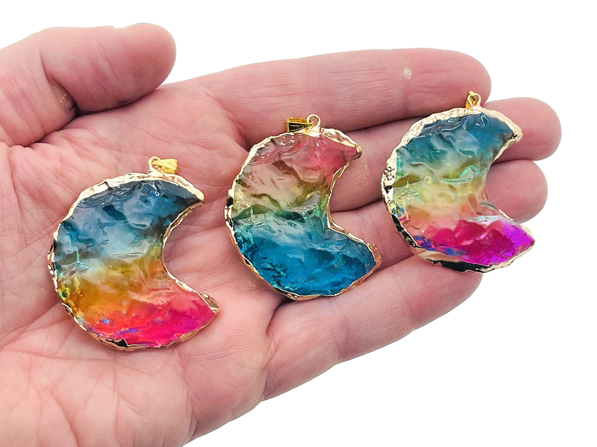 Blue, yellow, and pink rainbow aura moon crystal pendant from GemstoneGO, showcasing a loose crystal with vibrant iridescent colors.