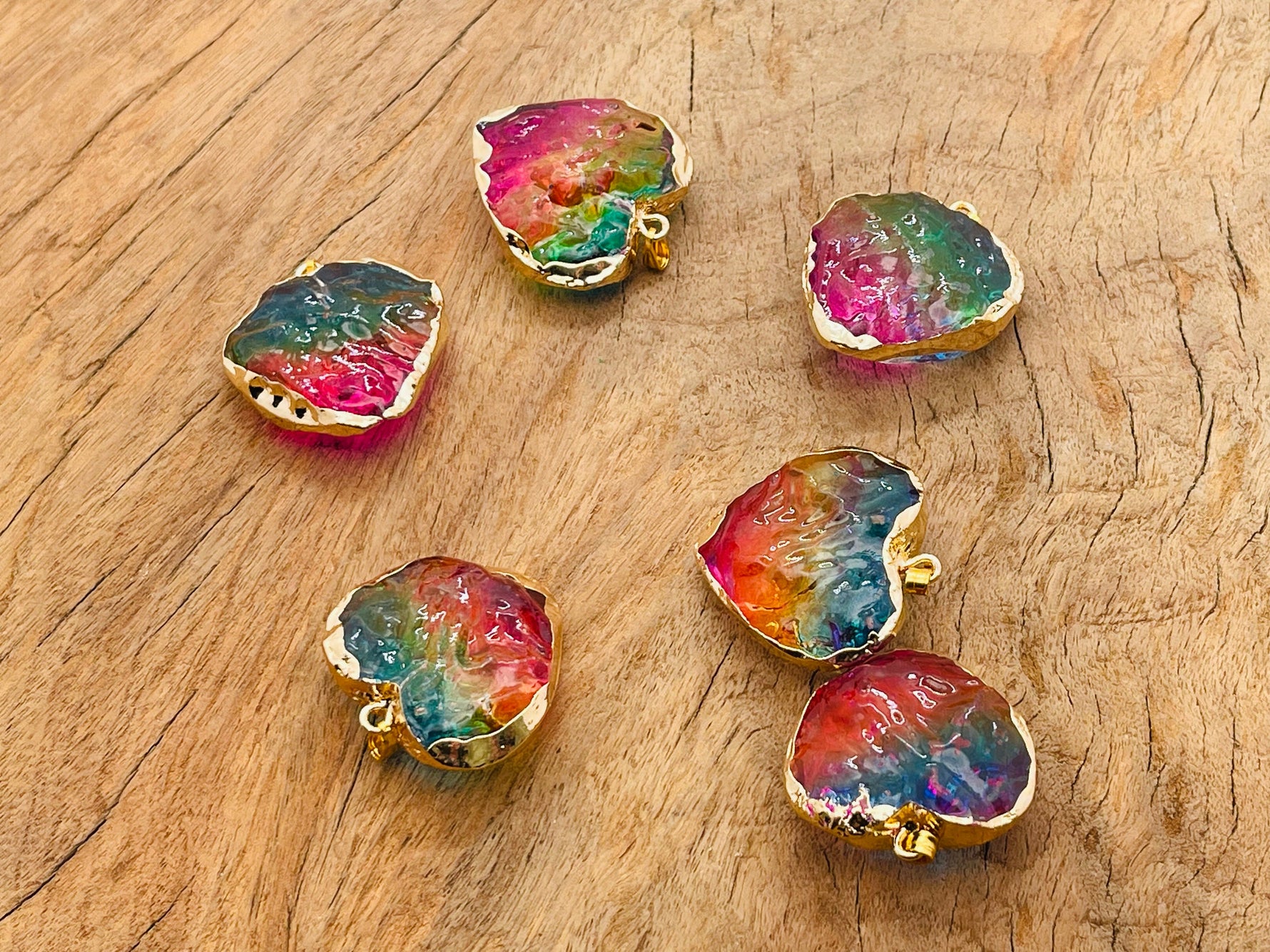 Rainbow Aura Heart crystal pendant with pink, yellow, and blue hues, featuring a loose gemstone from GemstoneGO.