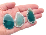 Green agate slice drilled gemstone pendant for jewelry making, showcasing a vibrant, polished geode crystal with natural banding.