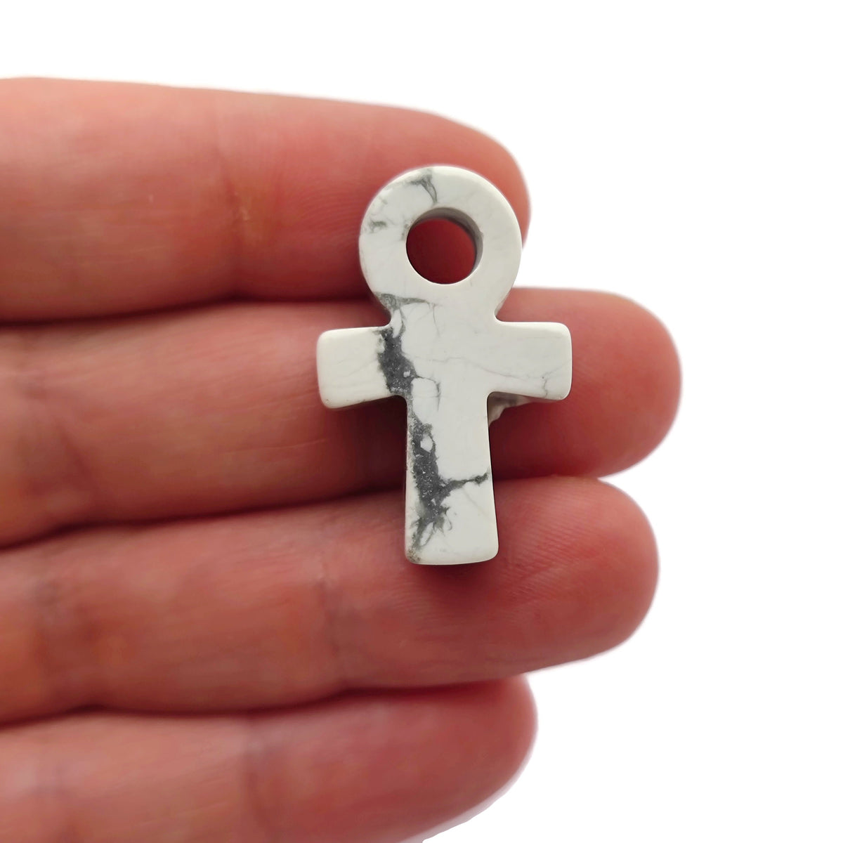 30mm Howlite Anka crystal carving with gemstone design, featuring elegant Ankh symbol, crafted by GemstoneGO.
